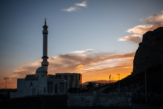 Mosque and Rock of Gibraltar silhouetted at sunset