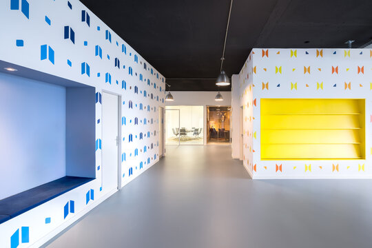 Colorful modern coworking office interior with empty shelving