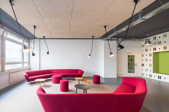 Modern coworking office lounge with vibrant pink seating