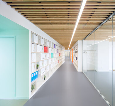 Modern coworking office corridor with storage and glass walls