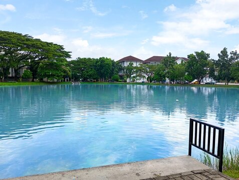 Beautiful Embung lake at UIN Raden Intan Lampung with blue sky and green trees, Indonesia