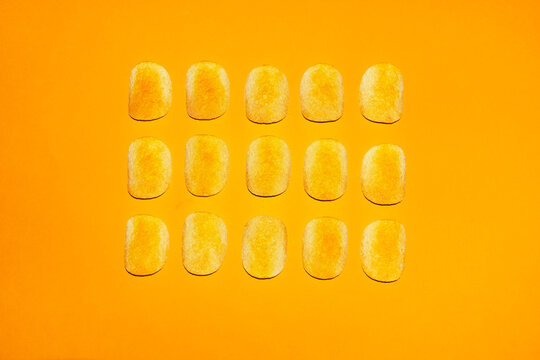 Potato chip grid on bright yellow background