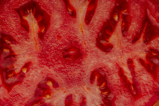 Macro view of sliced tomato showing juicy red texture