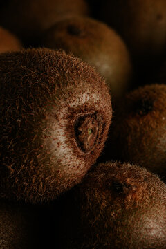 Close-up of whole kiwi fruit with fuzzy skin texture