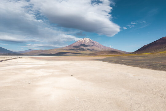 Volcanic peak above salt flat in the Andean Altiplano