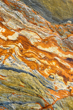 Abstract geological formation with vivid orange sedimentary layers