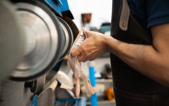 Artisan polish leather shoe on industrial buffing machine