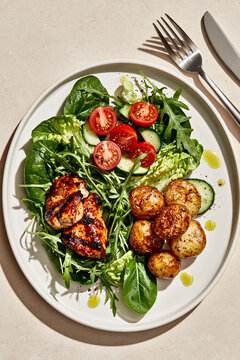 Grilled chicken salad with vegetables and roasted potato