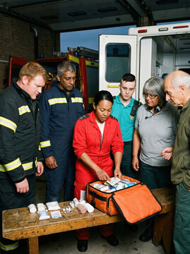 Emergency responder demonstrate first aid kit to rescue team