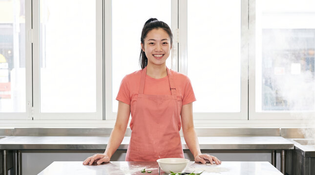 Asian woman cook preparing food in bright kitchen