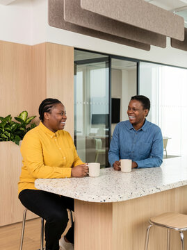 Colleagues share coffee after resolving workplace disagreement