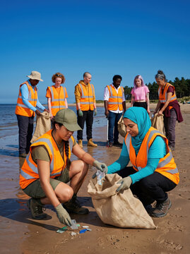 Clean coast crew volunteers load filled waste sacks