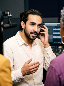 Podcast host speak with guest in professional recording studio