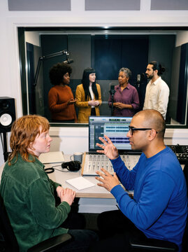 Podcast production team in professional recording studio