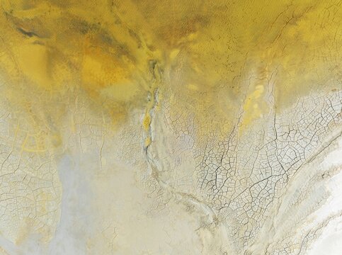 Abstract patterns in a waste pond in the mineral-rich area of the Rio Tinto mines. The colour is caused by oxidised iron minerals. Aerial view. Drone shot. Huelva province, Andalusia, Spain