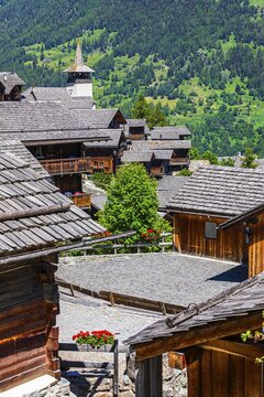 Old wooden houses with wooden shingle roofs in the historic centre of Grimentz, behind the church of Saint Theodule, Val d'Anniviers, Valais Alps, Canton Valais, Switzerland