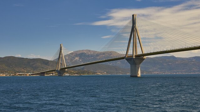 Long cable bridge over calm water with mountains in the background, Rio-Antirrio cable bridge, Patras, Peloponnese, Greece