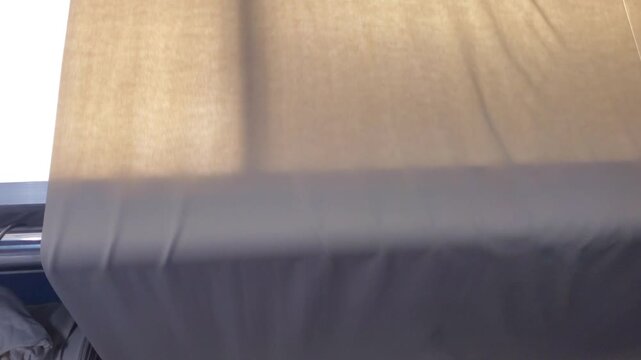 Fabric stretching on stenter machine with ruler measurement, textile finishing process in garment factory 4K
