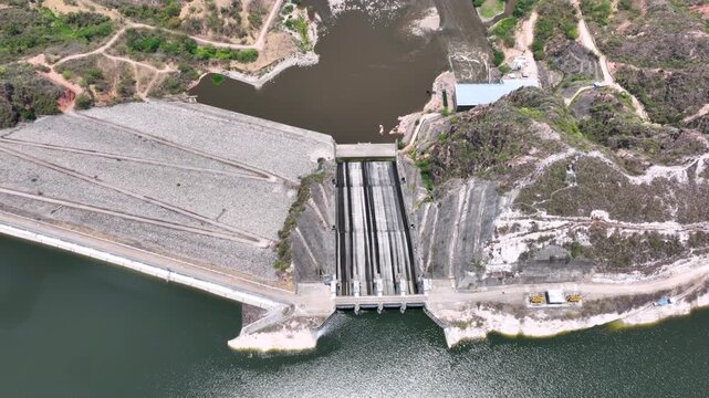 Large Hydroelectric Dam and Energy Infrastructure at El Quimbo Reservoir in Huila, Colombia. Establishing Shot. Aerial View.