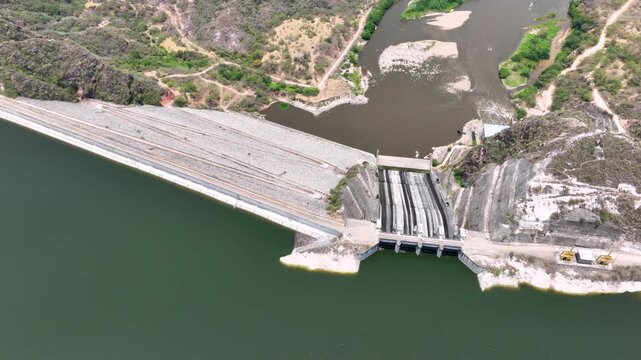 Large Hydroelectric Dam and Energy Infrastructure at El Quimbo Reservoir in Huila, Colombia. Establishing Shot. Aerial View.
