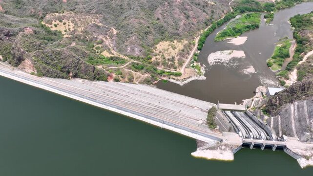 Large Hydroelectric Dam and Energy Infrastructure at El Quimbo Reservoir in Huila, Colombia. Establishing Shot. Aerial View.