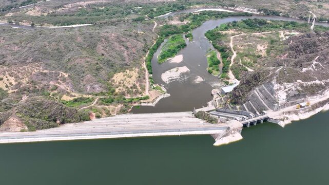 Large Hydroelectric Dam and Energy Infrastructure at El Quimbo Reservoir in Huila, Colombia. Establishing Shot. Aerial View.