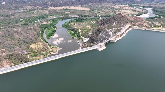 El Quimbo Dam Engineering and Hydroelectric Energy Infrastructure on the Magdalena River in Colombia. Establishing Shot. Aerial View.