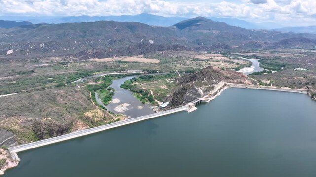 El Quimbo Dam Engineering and Hydroelectric Energy Infrastructure on the Magdalena River in Colombia. Establishing Shot. Aerial View.