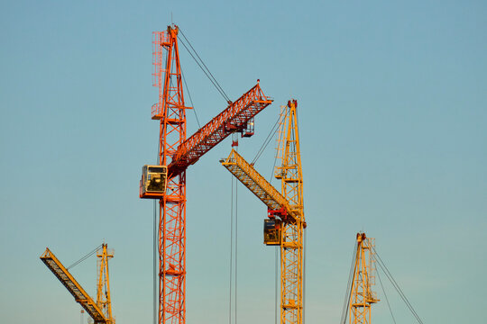 Heavy Tower Cranes Against Clear Sky at Sunset