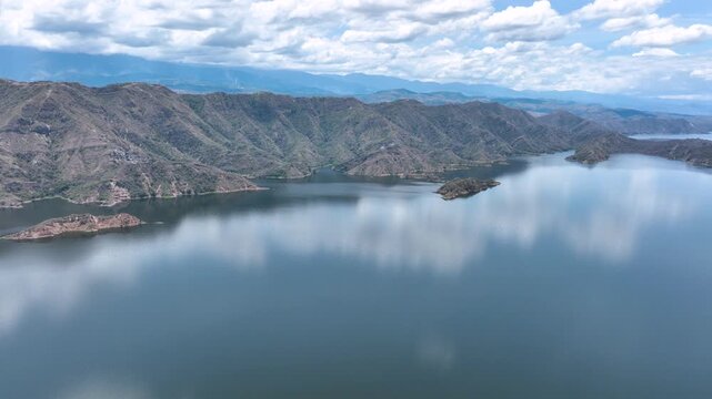 Expansive El Quimbo Hydroelectric Reservoir and Mountain Landscape in Huila, Colombia. Establishing Shot. Aerial View.