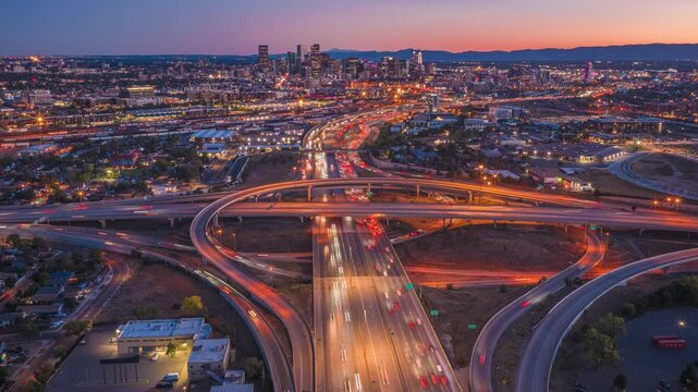 Denver urban landscape with highway interchange and blurred car light trails traffic drone hyperlapse 4K