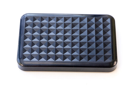 Black external hard drive with geometric textured surface