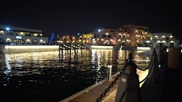Beautifully illuminated city waterfront at night in doha qatar