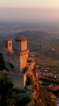 Flying over the amazing hilltop fortresses on Monte Titano in San Marino. San Marino one of the smallest countries in the world. Vertical Video.