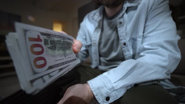 Man pulls a thick stack of money from a full wallet. Cash and banknotes are hard to take out. A lot of money, rich lifestyle, savings, income and personal finance concept