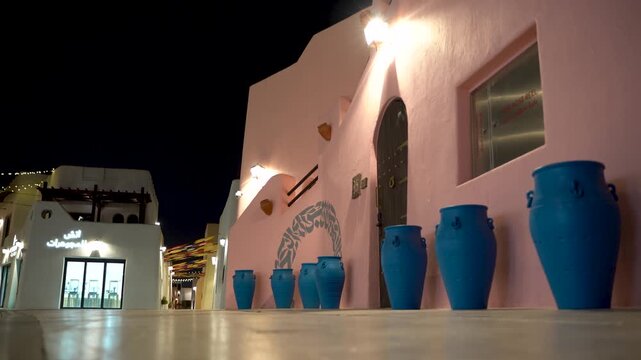 Traditional arabic architecture with blue vases at night