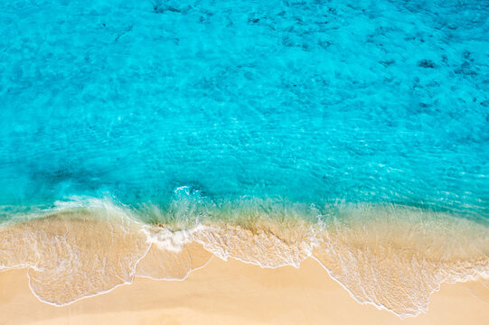 Serene aerial turquoise lagoon shallow water soft sandy shore tropical beach top down minimal summer calm. Peaceful ocean nature seascape scene. Meditation relax wellness design travel paradise