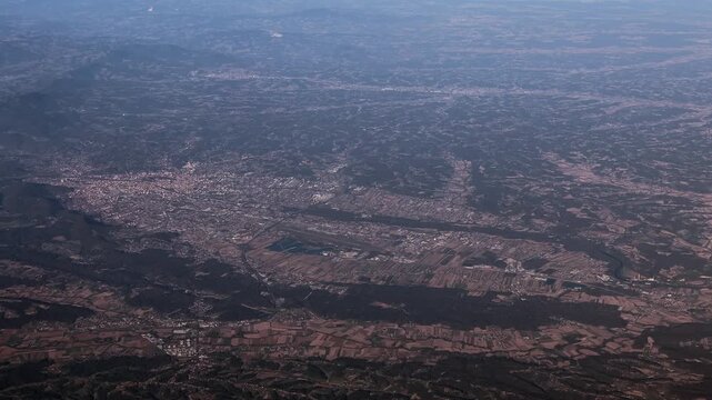 panoramic aerial overview - flying from south to north along City of Graz in Austria with Graz Airport, downtown Graz and suburbs, as well as agricultural landscape around the city - 4k aerial video 