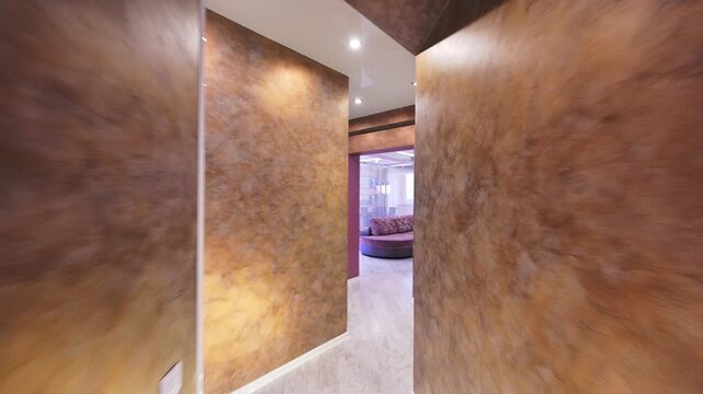 Stylish entryway features textured plaster walls, dark wood door with glass panels, built-in storage, mirror, and wall hooks