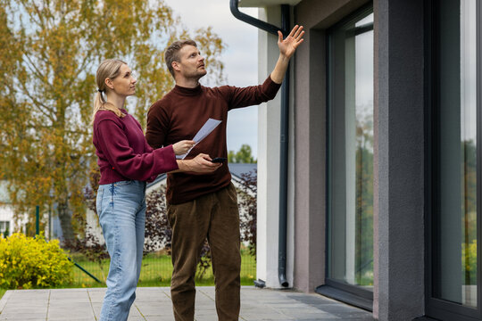 Real estate agent showing modern house to client. Realtor and customer inspecting property before buying