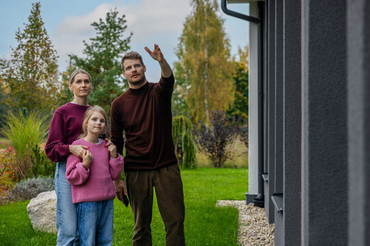 Family viewing modern new house before buying