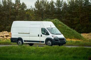 Commercial vehicle driving near green fields © AlexGo