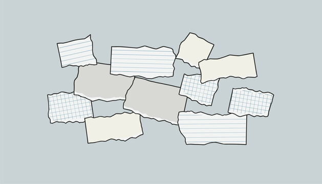 A collection of various torn and ripped paper scraps, including lined notebook paper and grid paper, arranged in a messy pile.