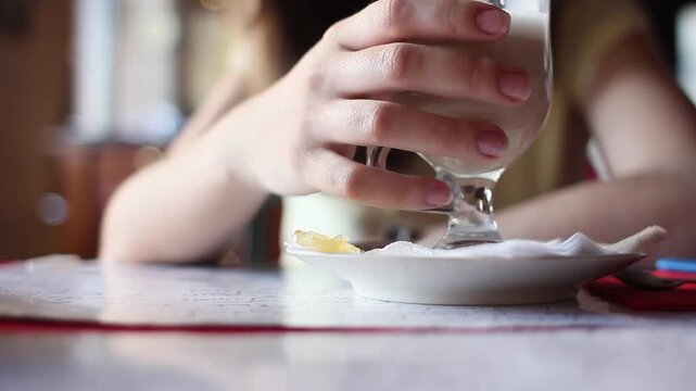 Woman drinking latte in restaurant