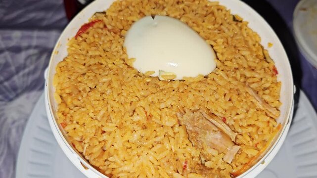 Fragrant mutton bucket biryani served with a boiled egg, packed with aromatic basmati rice, tender meat, and traditional South Asian spices.
