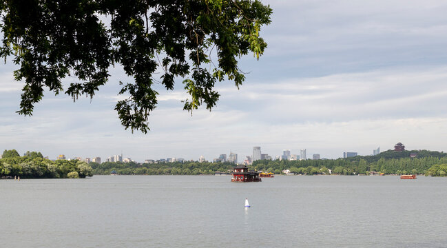 Pleasure boats on West Lake, with Leifeng Pagoda, Hangzhou, China