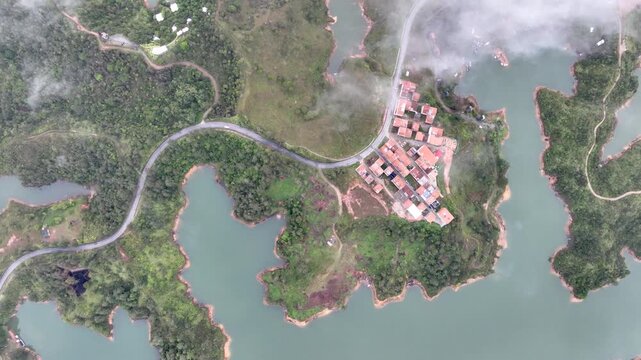El Pe&ntilde;&oacute;n de Guatap&eacute; Rising Above Guatap&eacute; Reservoir in Antioquia, Colombia. Establishing Shot. Aerial View.