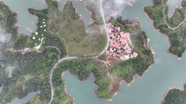 El Pe&ntilde;&oacute;n de Guatap&eacute; Rising Above Guatap&eacute; Reservoir in Antioquia, Colombia. Establishing Shot. Aerial View.