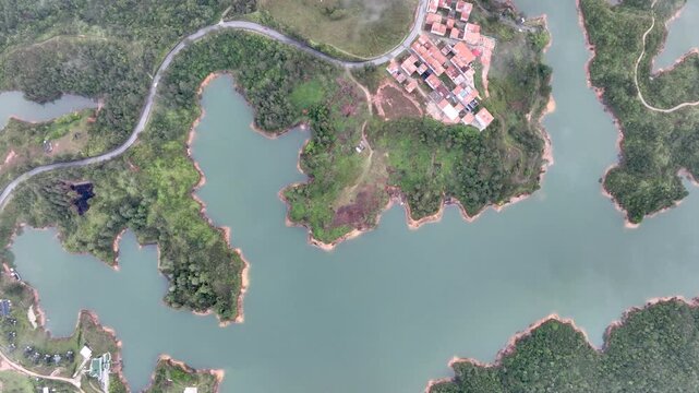 El Pe&ntilde;&oacute;n de Guatap&eacute; Rising Above Guatap&eacute; Reservoir in Antioquia, Colombia. Establishing Shot. Aerial View.