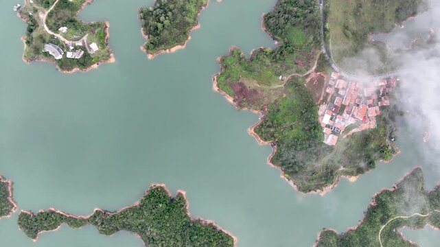 El Pe&ntilde;&oacute;n de Guatap&eacute; Rising Above Guatap&eacute; Reservoir in Antioquia, Colombia. Establishing Shot. Aerial View.